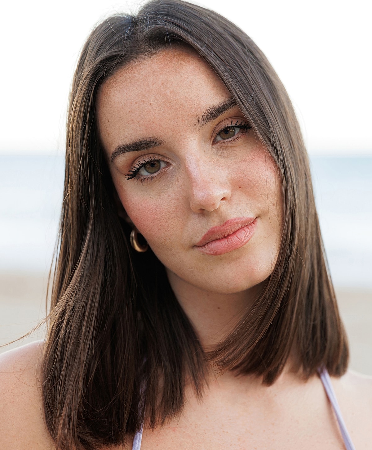 Young woman with long hair at the beach.