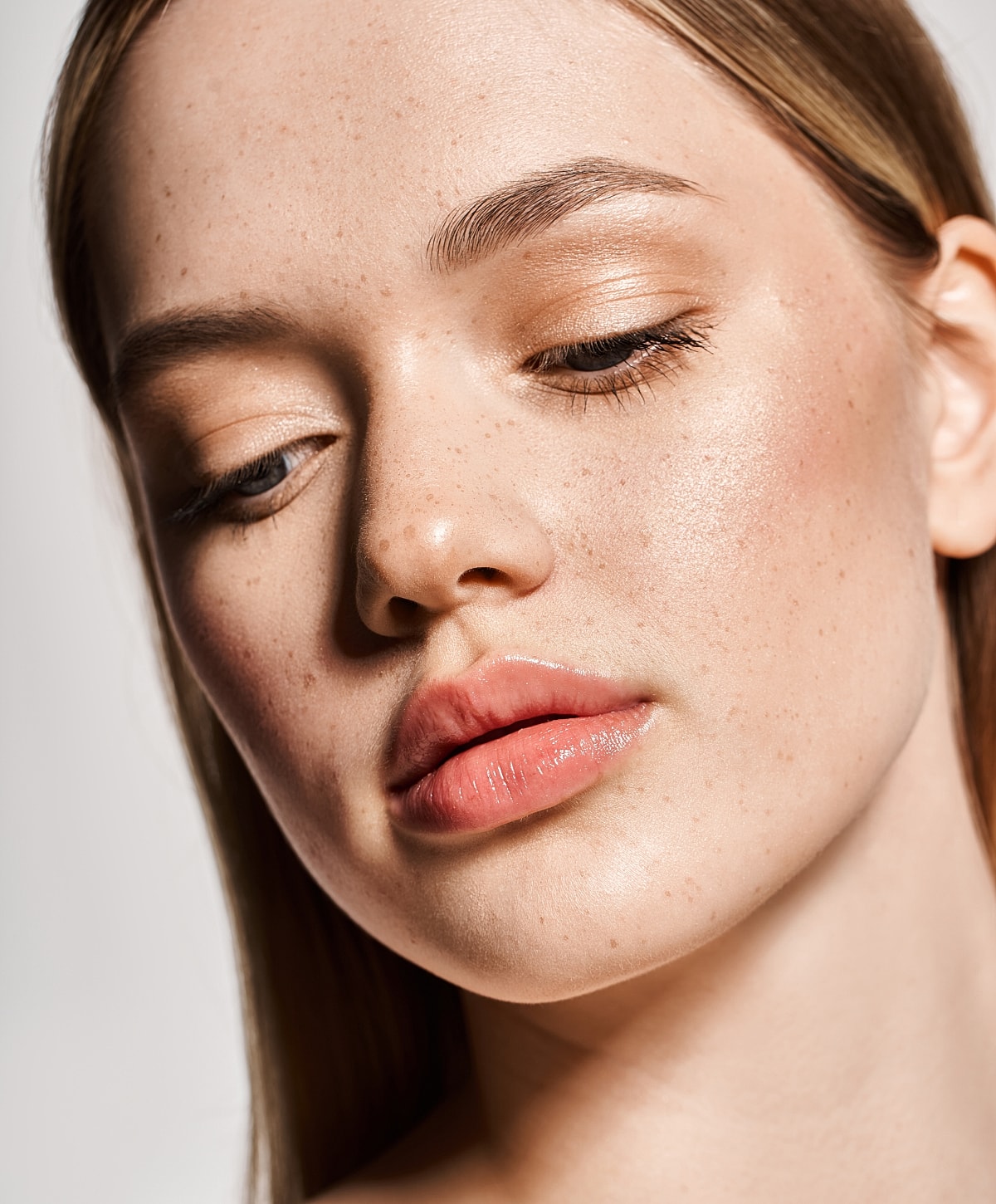 Close-up of a woman's freckled face.