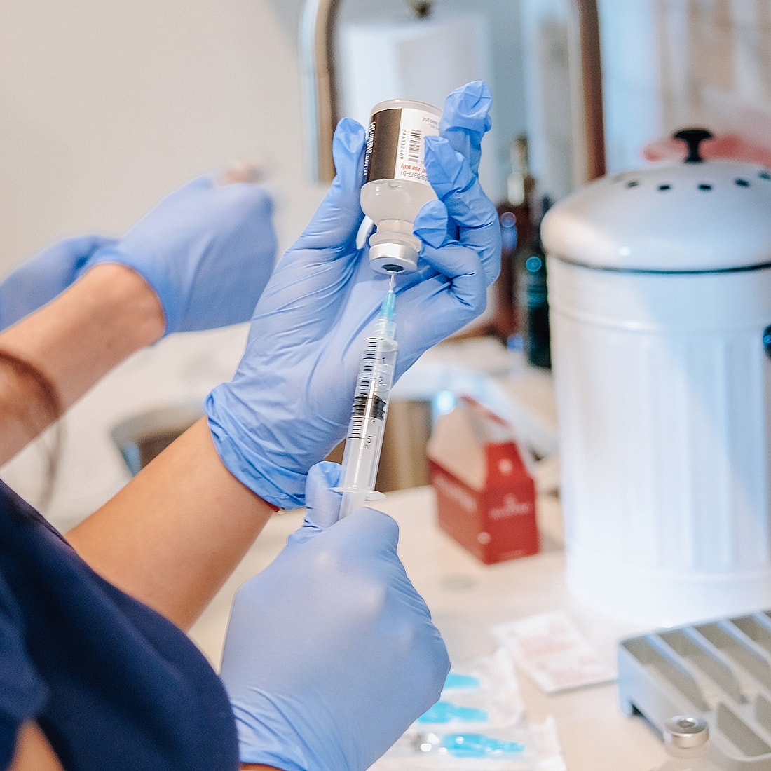 Preparing a syringe with medical solution.