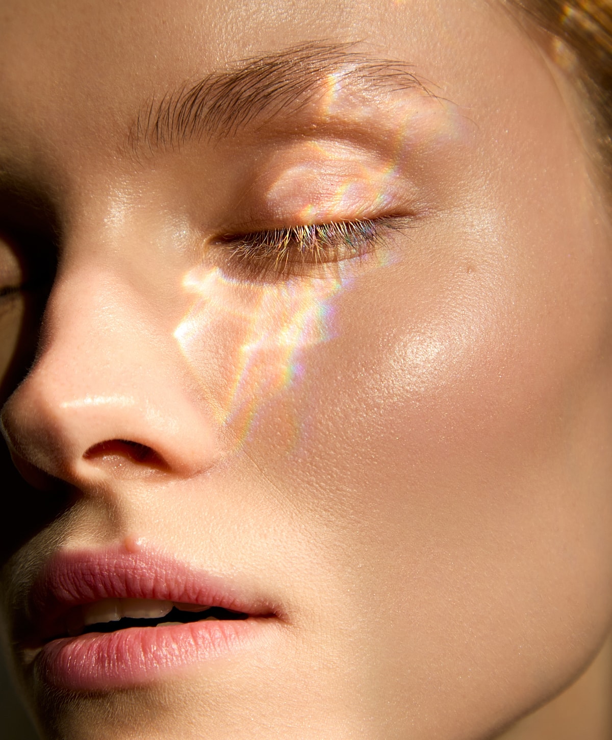 Close-up of radiant, glowing skin with sunlight.
