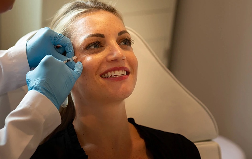 Woman receiving aesthetic treatment in a clinic.
