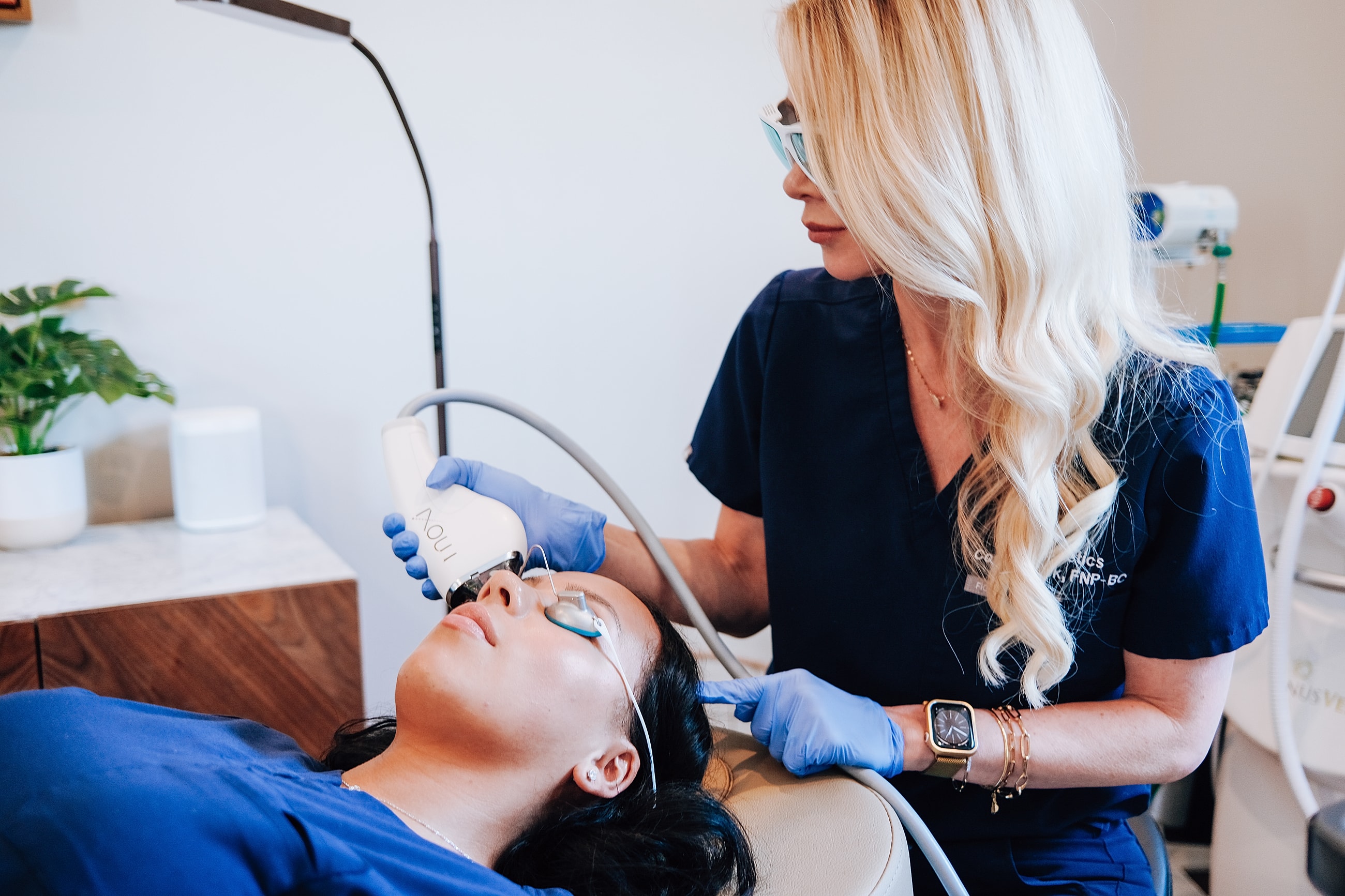 Skin treatment session with professional aesthetician assisting.