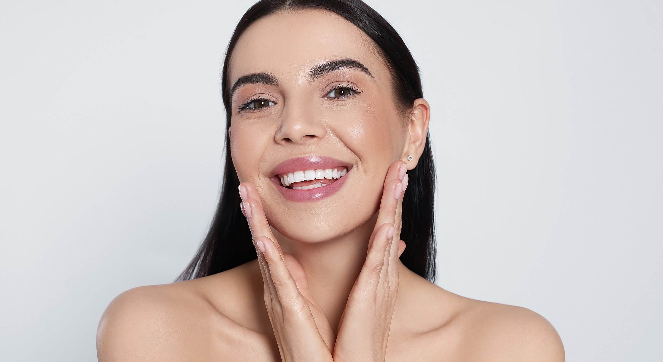 Smiling woman with glowing skin and healthy expression