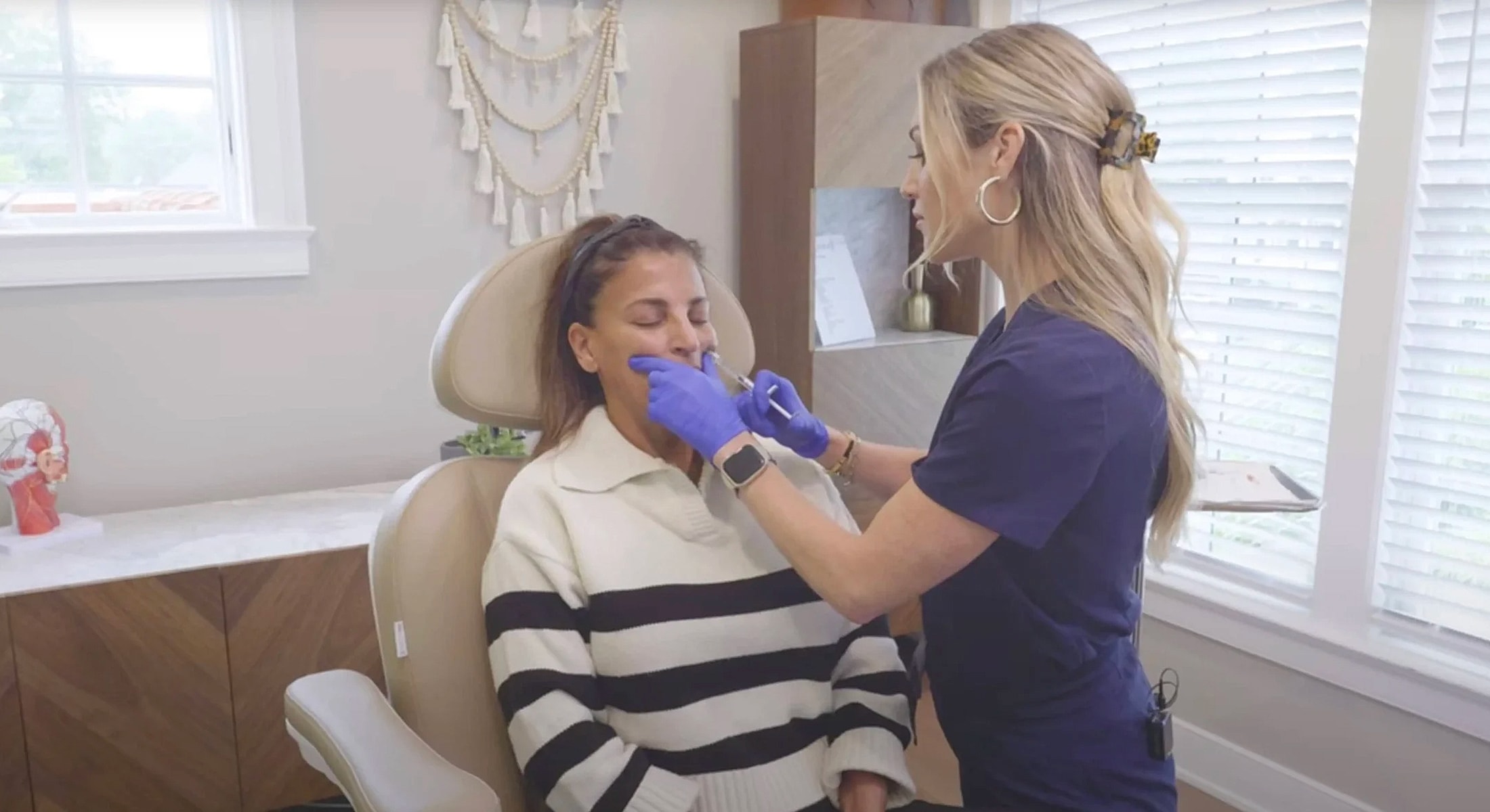 Patient receiving cosmetic treatment in clinic setting.