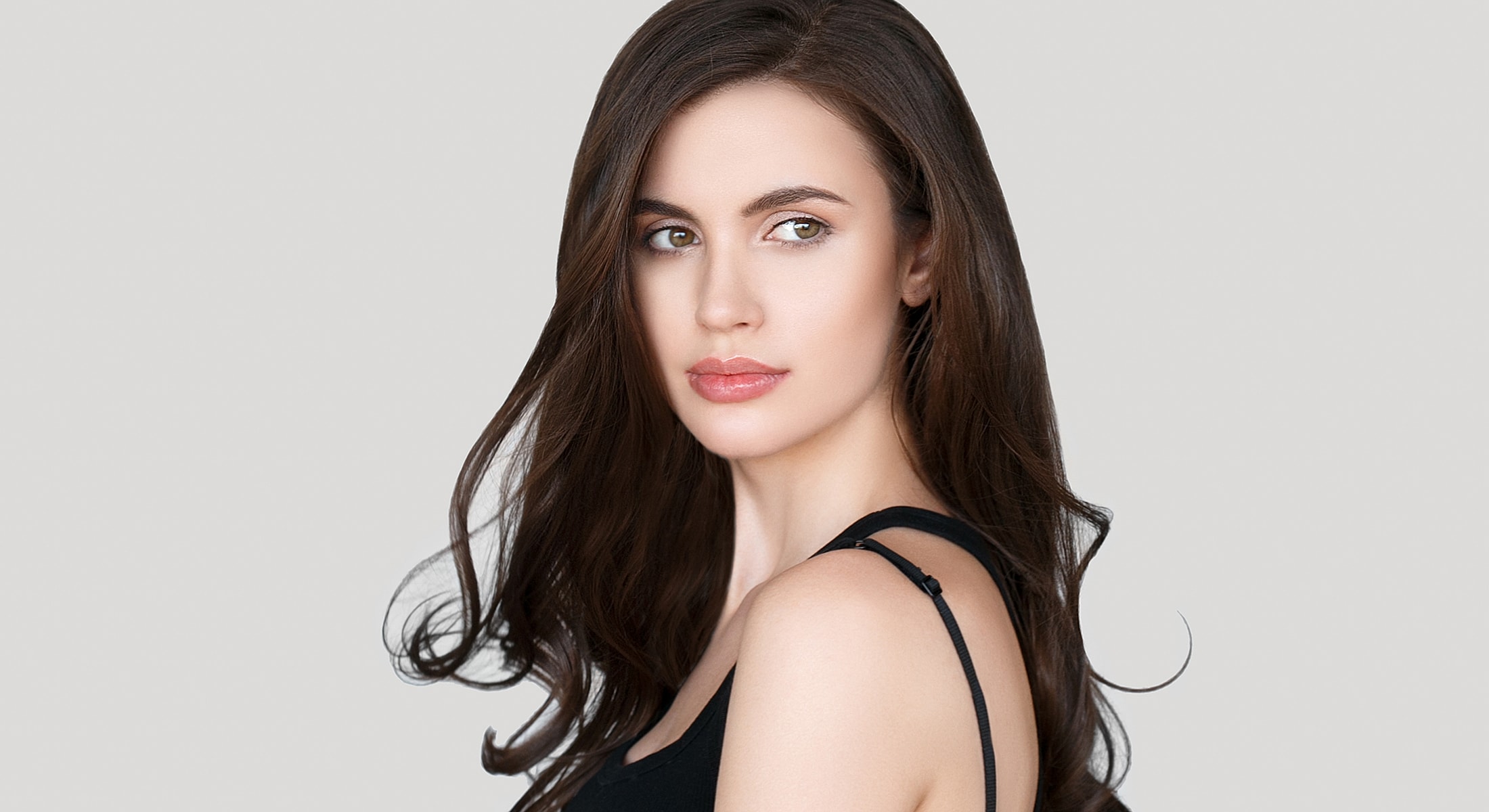 Woman with long hair and natural makeup.